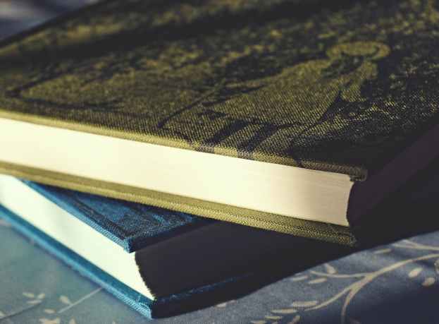 green and blue labeled books