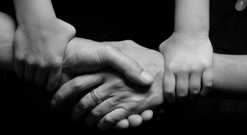black and white connected hands love
